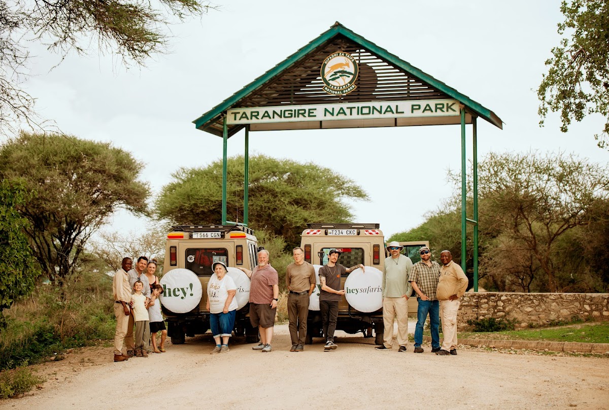 A Last Life Ever group with their safari trucks at the gate of Tarangire National Park